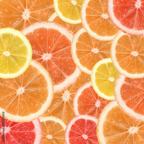 A slice of lemon, orange and grapefruit on a white background