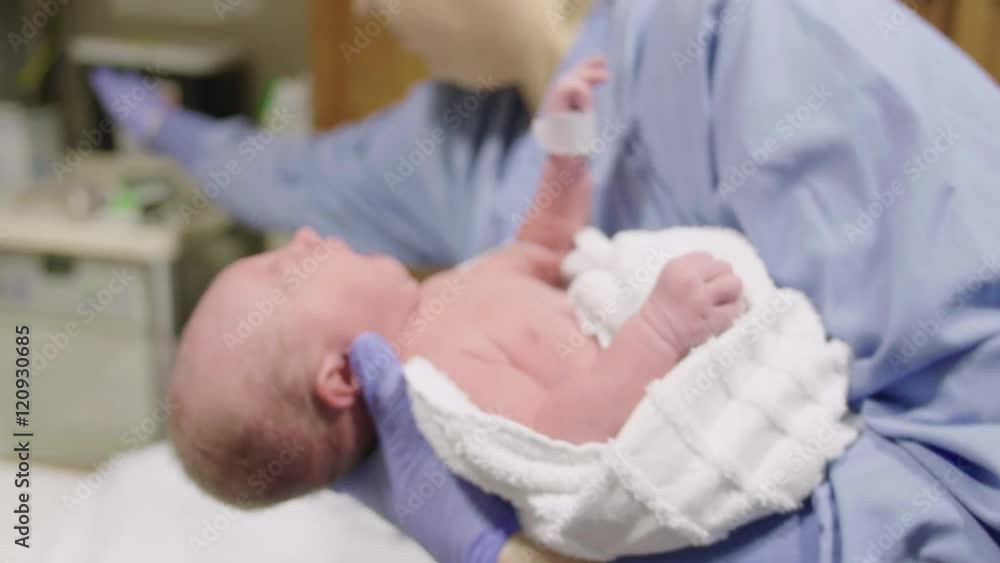 Nurse Cleans Head of Newborn Baby After Birth in Hospital Nurse Cleans Head of Newborn Baby After Birth in Hospital