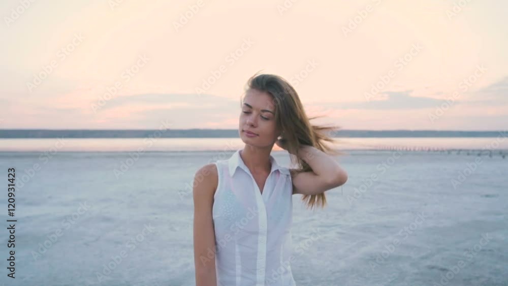 Young attractive female on the beach during sunset Young attractive female on the beach during sunset