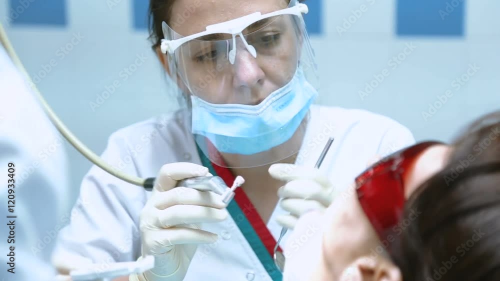 dentist with medical equipment treats teeth of patient dentist with medical equipment treats teeth of patient