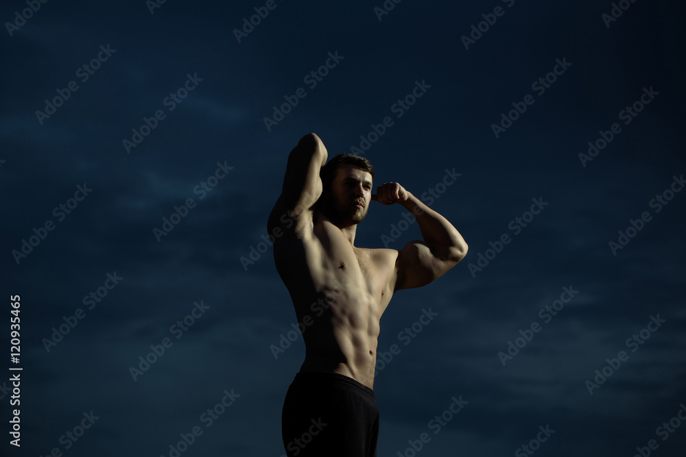 sexy muscular macho man on blue sky