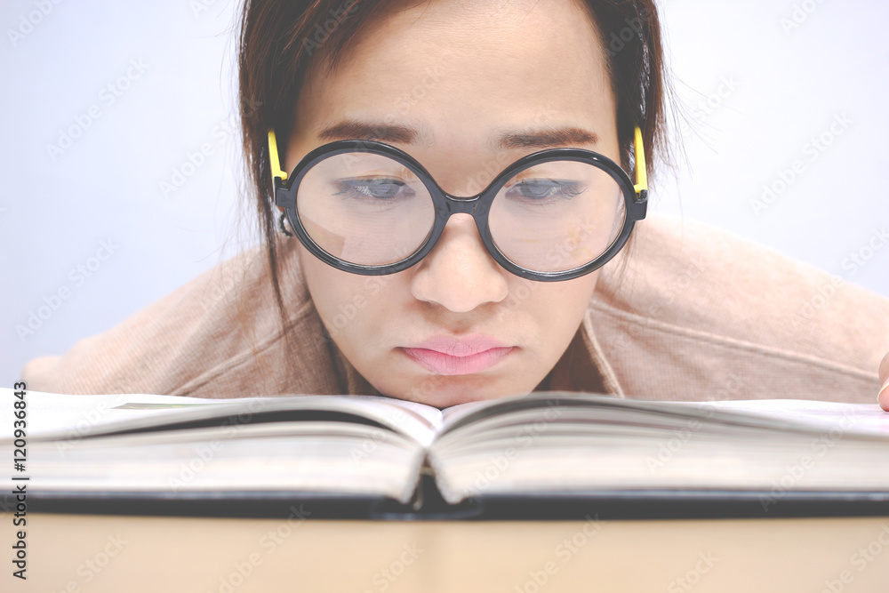 Nerdy young asian woman student with old big round glasses bored 