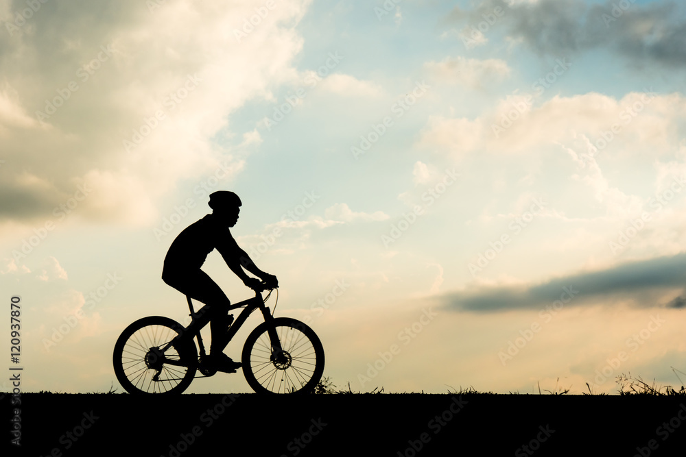 Fototapeta premium Silhouette of cyclist motion on sunset background