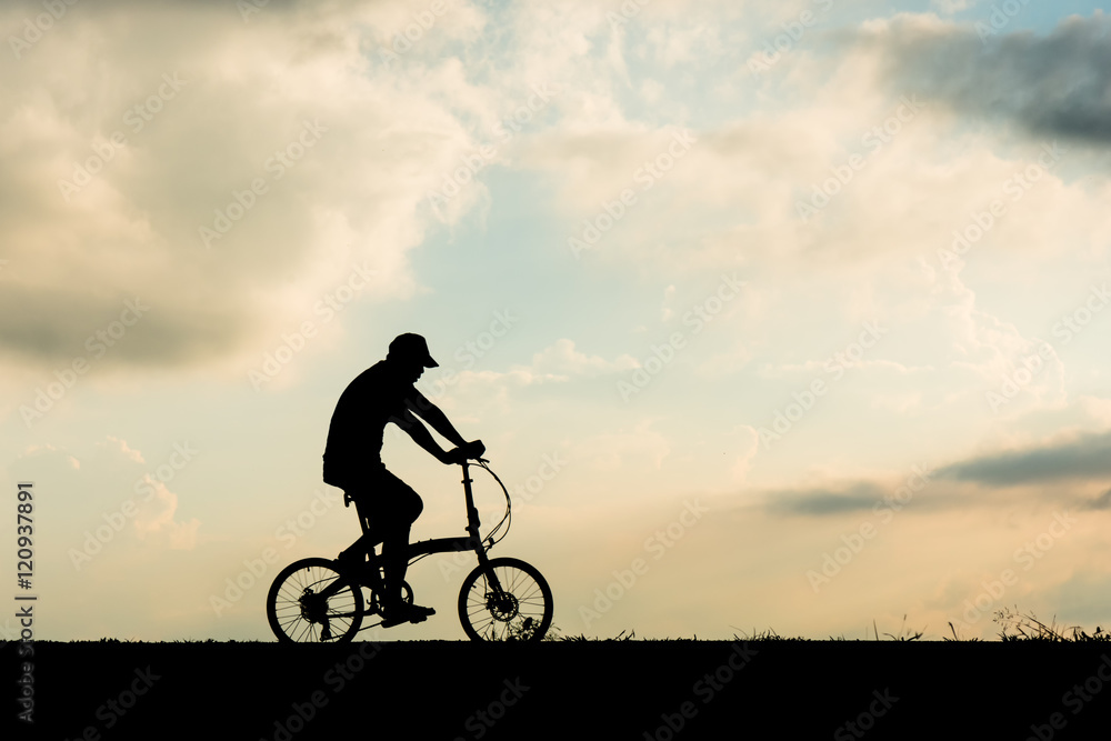 Silhouette of cyclist motion on sunset background Silhouette of cyclist motion on sunset background