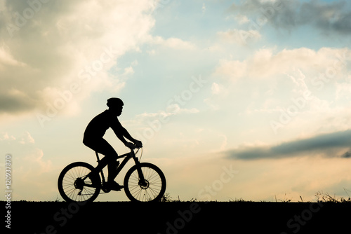 Fototapeta Naklejka Na Ścianę i Meble -  Silhouette of cyclist motion on sunset background