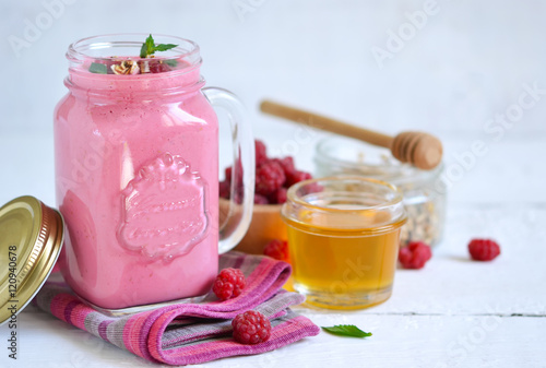 Berry smoothie in a glass jar on the breakfast with raspberries,