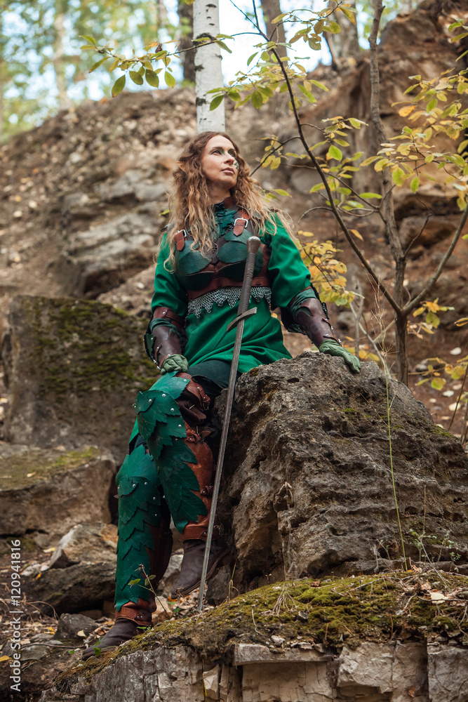 Elf woman in green leather armor with the sword