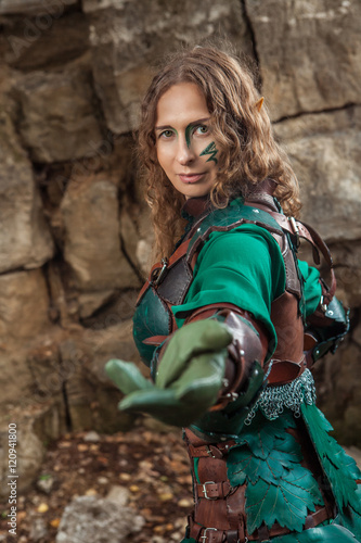 Elf woman in green leather armor is inviting you.