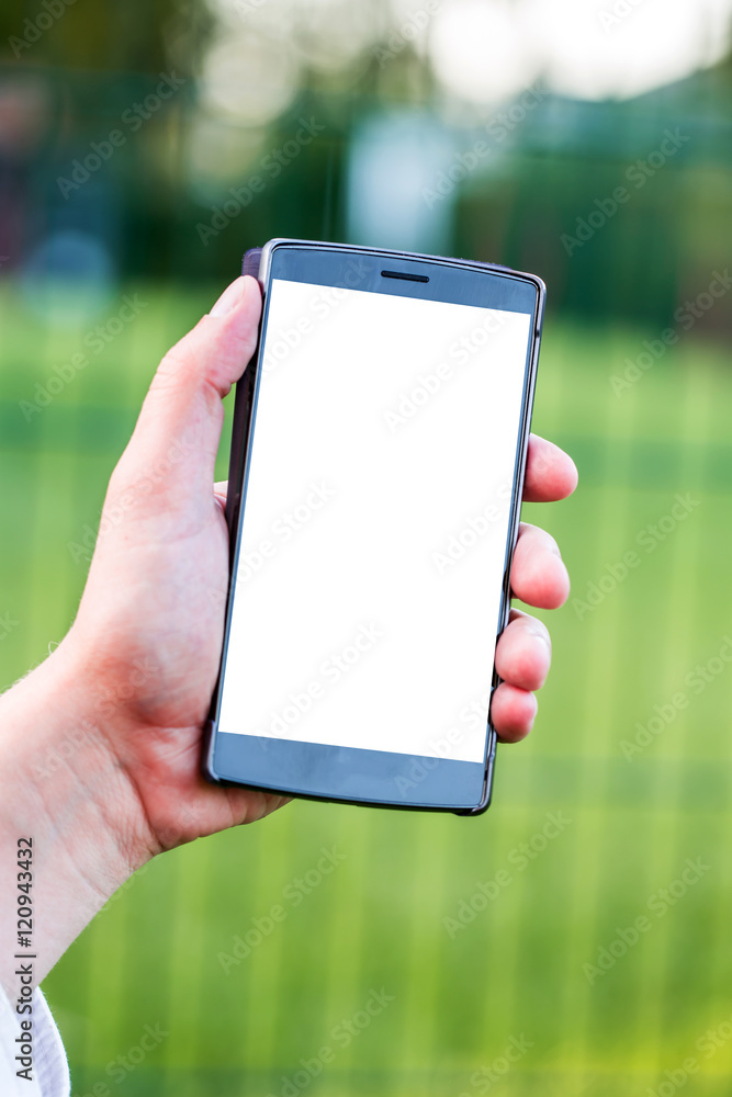 Smartphone with blank space on Hand of Caucasian Business Man holding Cellphone over Blurred garden outdoor background. Image for Advertising online Application Solution or Mobile banking Concept.