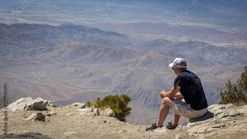 Young man viewing distant San Bernadino mountains from Keys View, Joshua Tree National Park, California photo