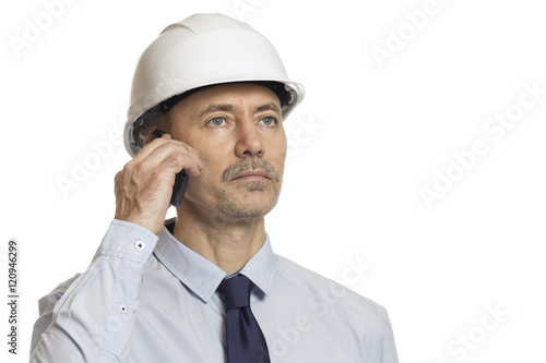 businessman with a phone in a construction helmet