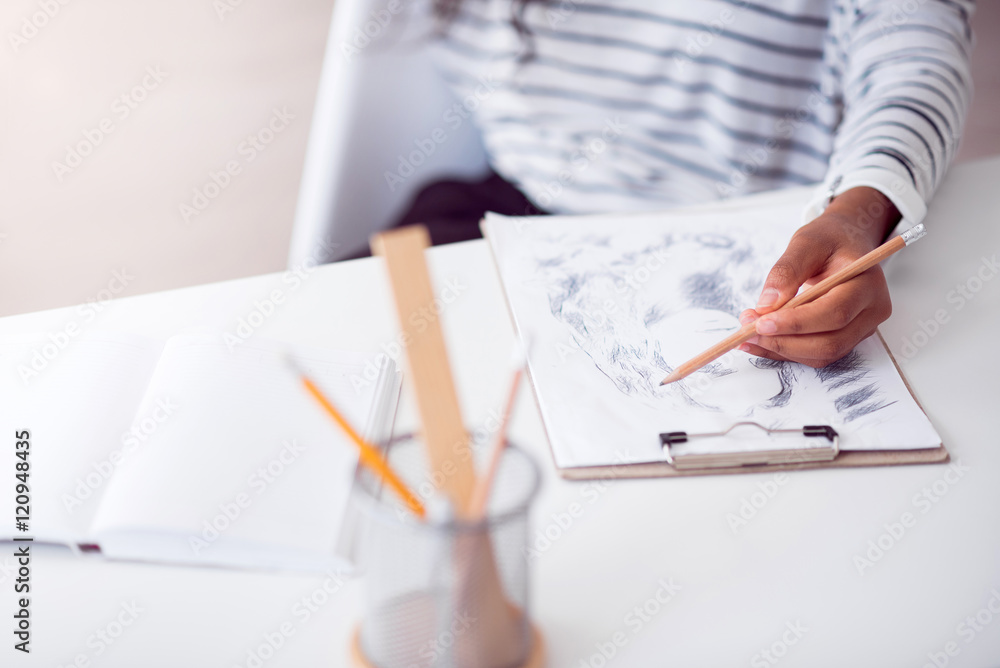 Pleasant woman drawing a portrait. Pleasant woman drawing a portrait.