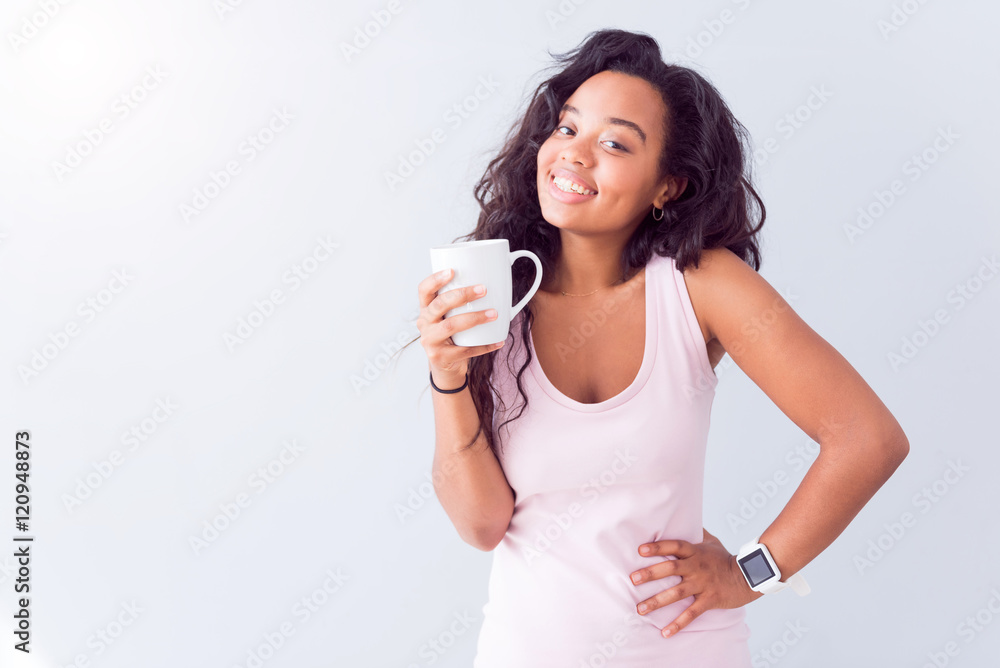 Positive woman drinking tea