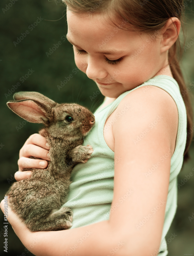 Girl is holding a little rabbit Girl is holding a little rabbit