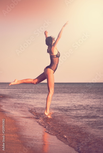 Fototapeta Naklejka Na Ścianę i Meble -  Black bikini sea, jump ballet, landscape, toned