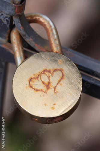 Aged and shabby closed padlock. Security concept. Macro view, soft focus