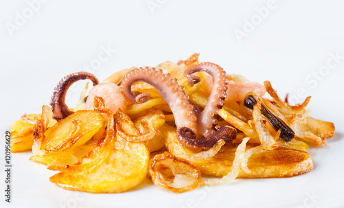 Appetizer of cuttlefish octopus, mussels, shrimp and fried potatoes. White background. Copy space for your design. macro view