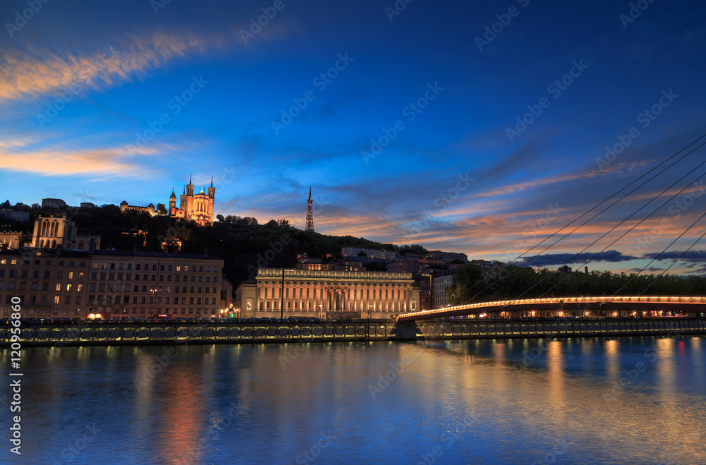 Colorful sunset over the Saone river and the Basilique Notre-Dame de Fourviere in the city of Lyon, France.