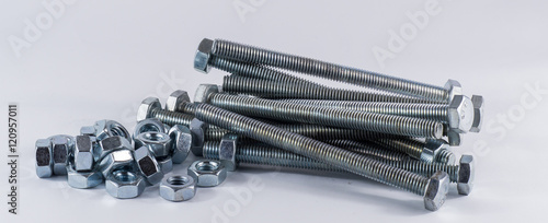 Bolts and screws on a white background. Bolts and screws used in construction. Tightening around the neck. Bolts and screws are descendants of mainly made of fine steel. Bolts and screws in isolate.