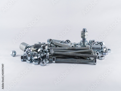 Bolts and screws on a white background. Bolts and screws used in construction. Tightening around the neck. Bolts and screws are descendants of mainly made of fine steel. Bolts and screws in isolate.