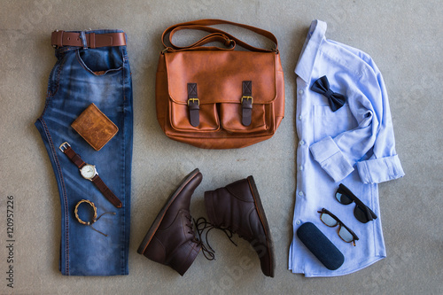Flat lay of men's casual outfits with accessories on gray background 