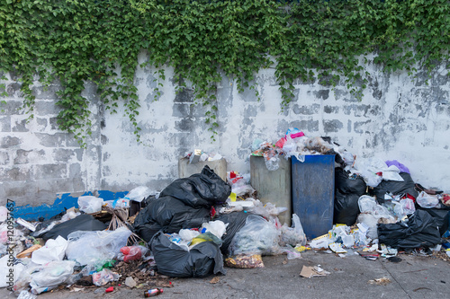 Dumpsters being full with garbage in the evening