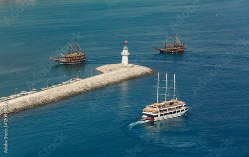 Lighthouse with party boats around. Alanya, Turkey