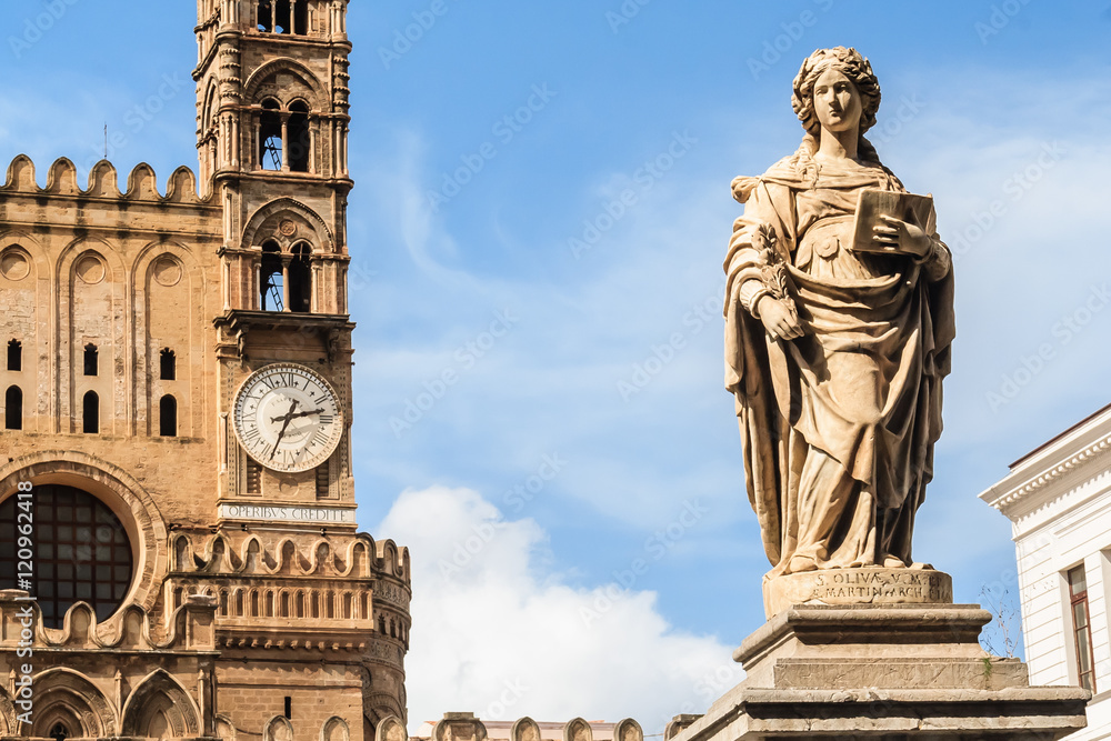 Statue of Saint Olivia. Cathedral in Palermo with the clock