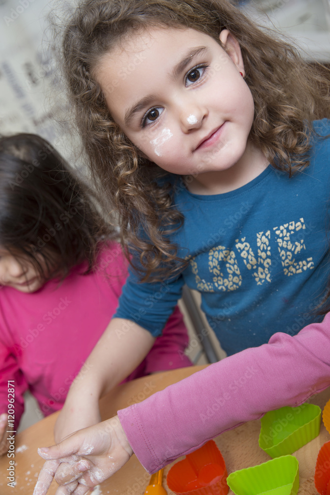 Four years girl with dirty face cooking in a kitchen Four years girl with dirty face cooking in a kitchen