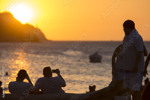 Colombian peole on the beach of Taganga during the sunset, Colom photo