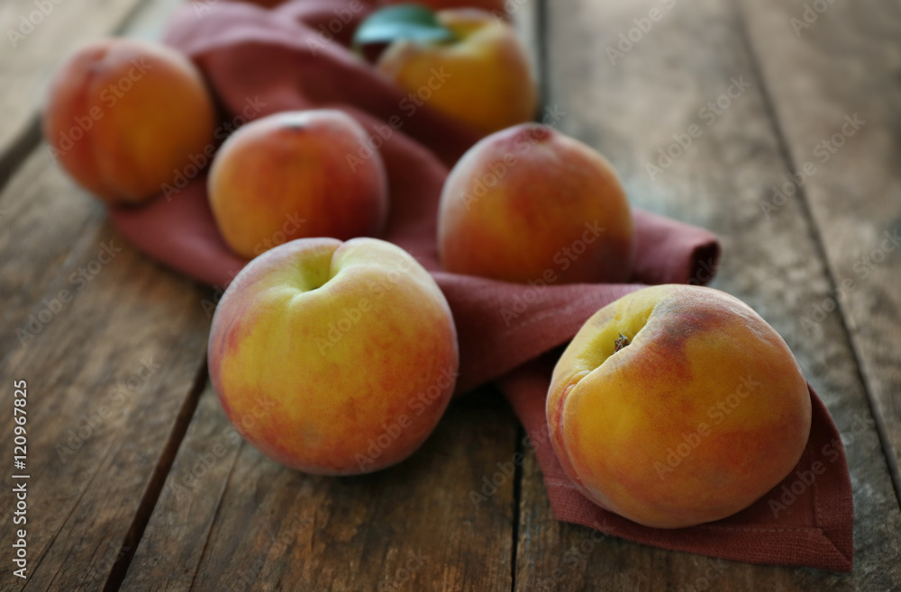 Fresh peaches on a wooden background