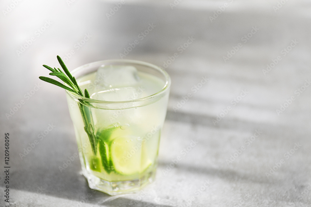 Cold fresh cocktail with lime on light background Cold fresh cocktail with lime on light background