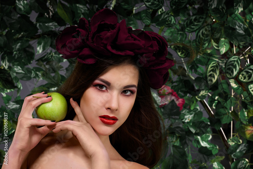 beautiful girl with a wreath on his head with apple