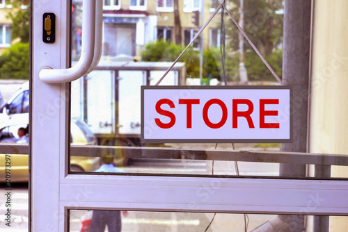 A sign with red letters on the front door photo