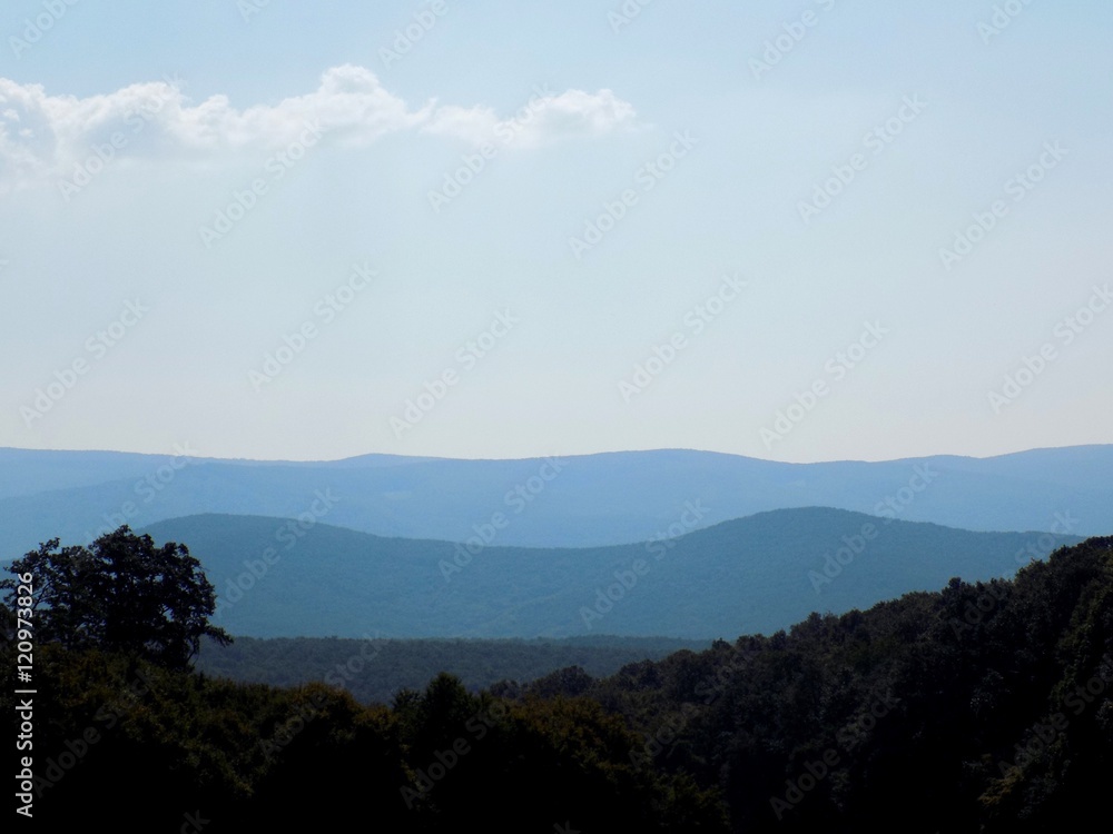 Hills in mountains silhouette during day in wild nature