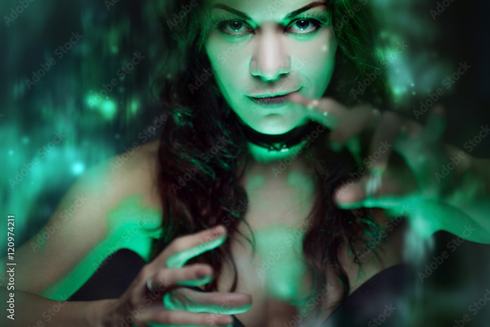 Witch creates magic. Beautiful and sexy woman with a mystical light Witch creates magic. Beautiful and sexy woman with a mystical light