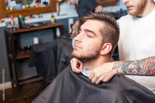 Young man having hair cutted