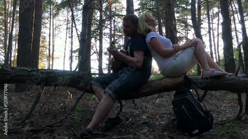 The family in the woods playing guitar