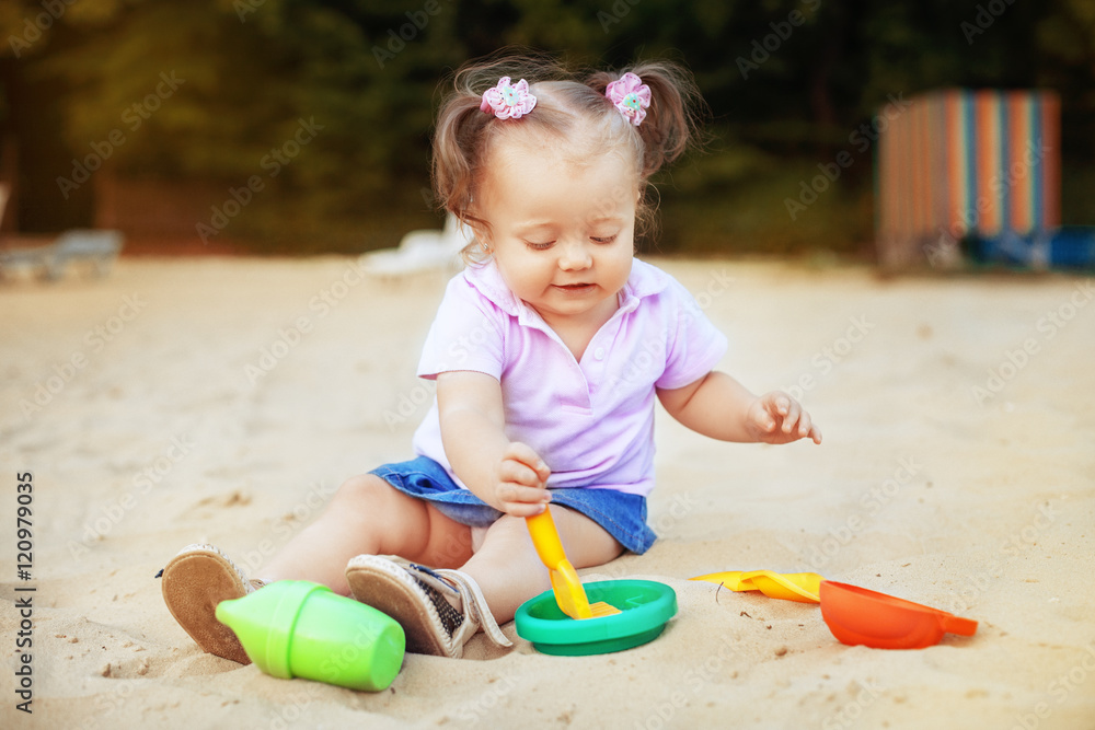 funny little kid playing in the sand. Top view. The concept of childhood and development. funny little kid playing in the sand. Top view. The concept of childhood and development.