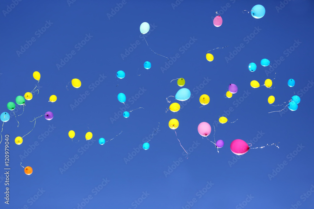 many multicolored balloons flying in the blue sky many multicolored balloons flying in the blue sky