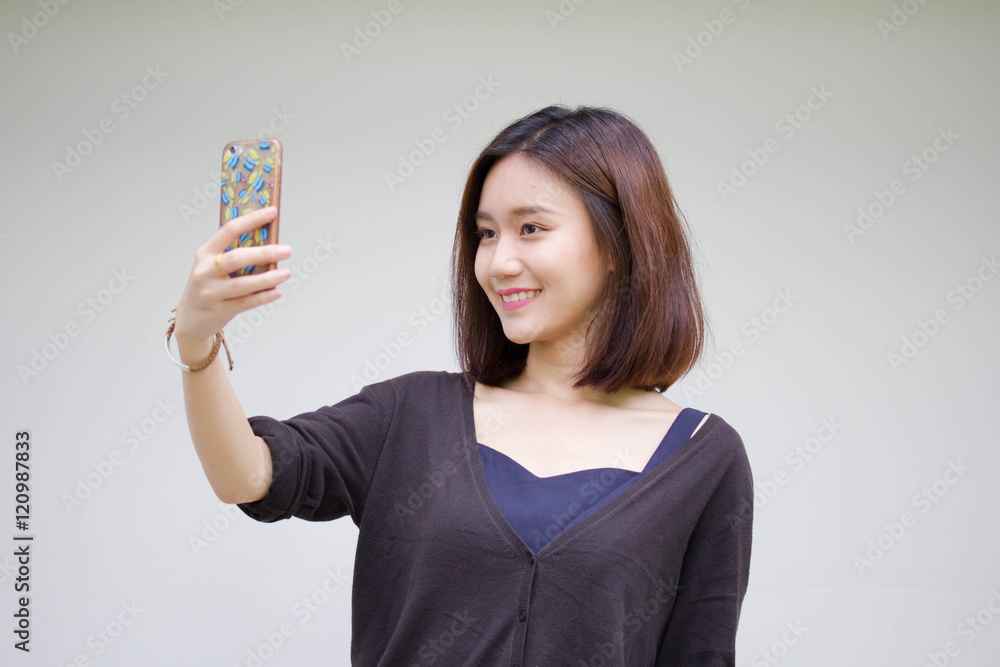 Portrait of thai adult student university beautiful girl using her smart phone Selfie Portrait of thai adult student university beautiful girl using her smart phone Selfie