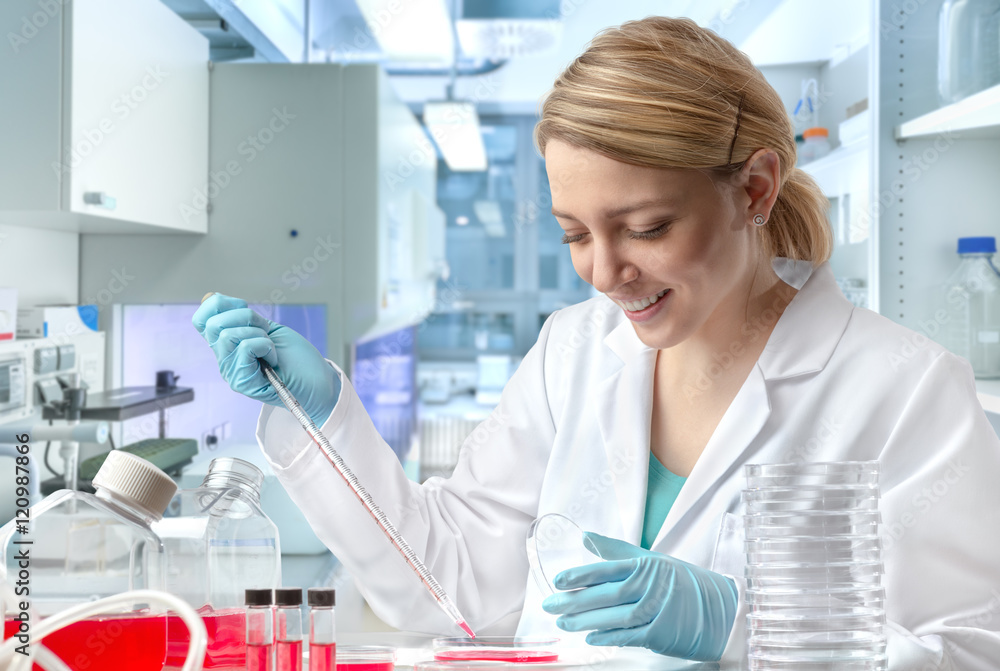 Young European female scientist or tech works in laboratory Young European female scientist or tech works in laboratory
