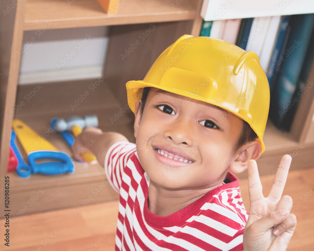 Little asian boy playing with toys tools in house. Little asian boy playing with toys tools in house.