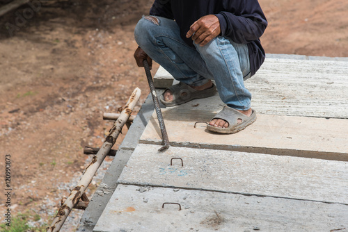 Builder worker man installing cement floor slab panel at building construction site