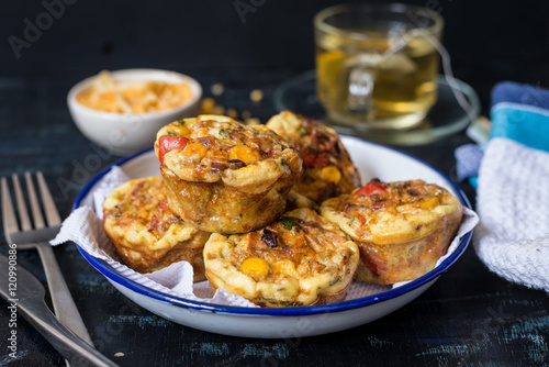 Mexican egg muffin on white plate with tea cup on the table