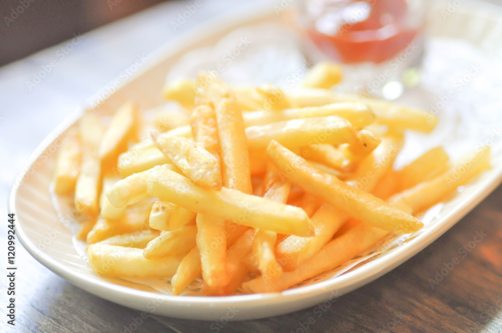 French fries  and ketchup dip in soft focus
