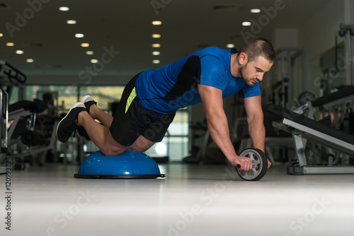 Young Man Doing Exercise On Bosu Balance Ball © Jale Ibrak