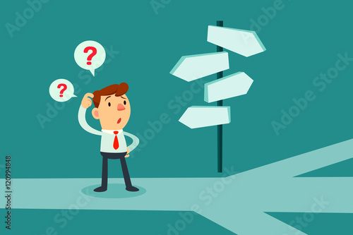 businessman confused by direction signs