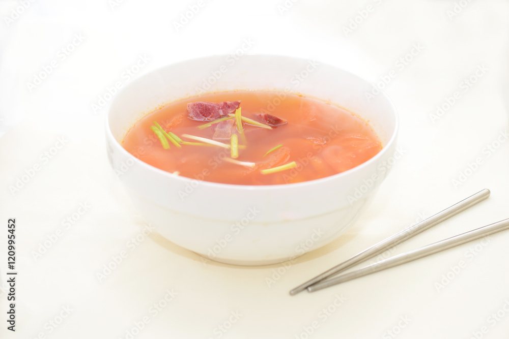 Tomato mushroom soup on white bowl in white background Tomato mushroom soup on white bowl in white background
