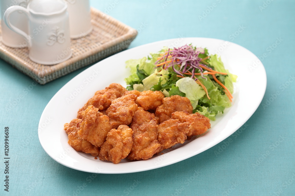 Sunsal fried Chicken Take Ake with salad on white plate with tea Sunsal fried Chicken Take Ake with salad on white plate with tea